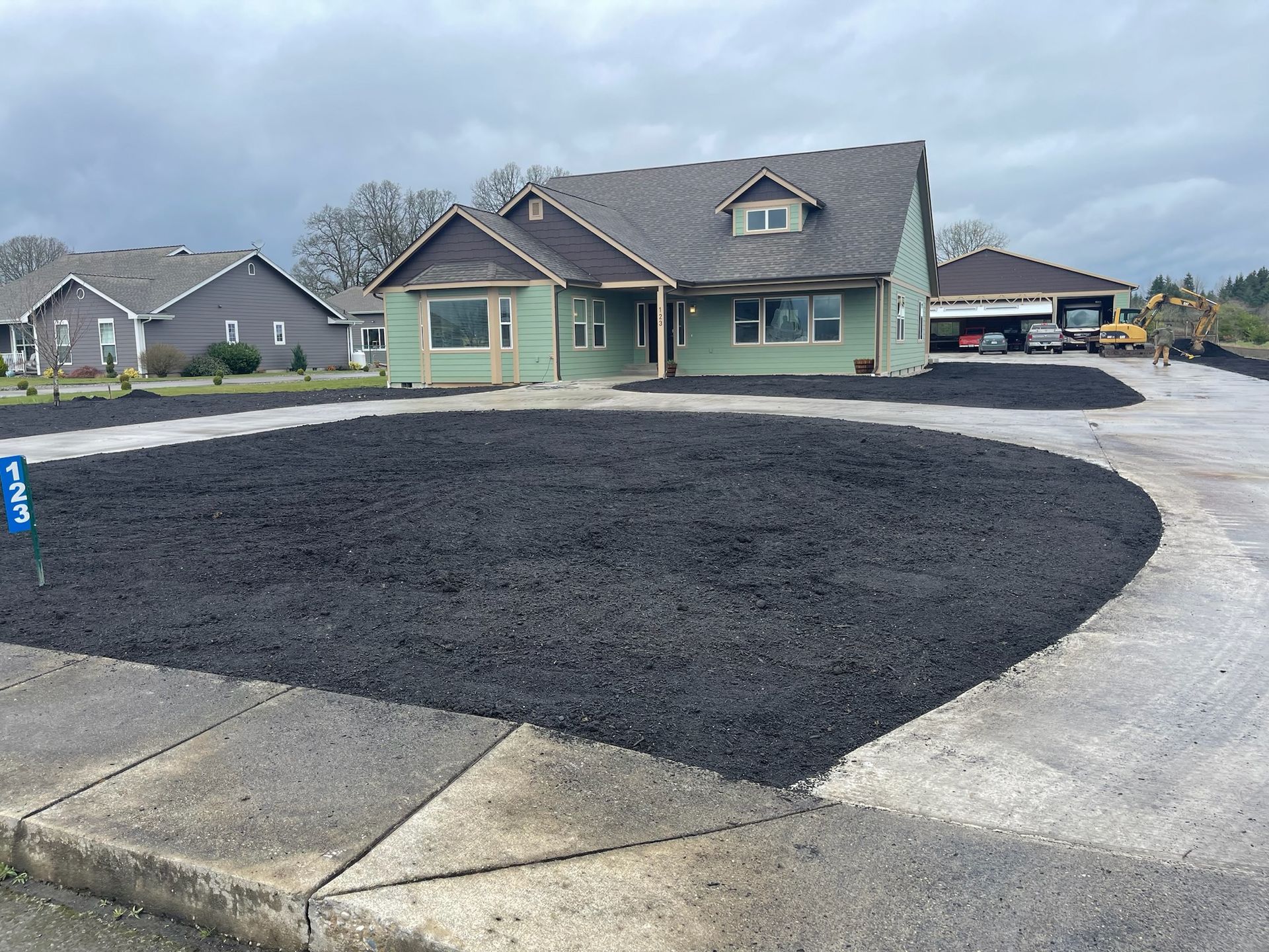 A house with a lot of black gravel in front of it
