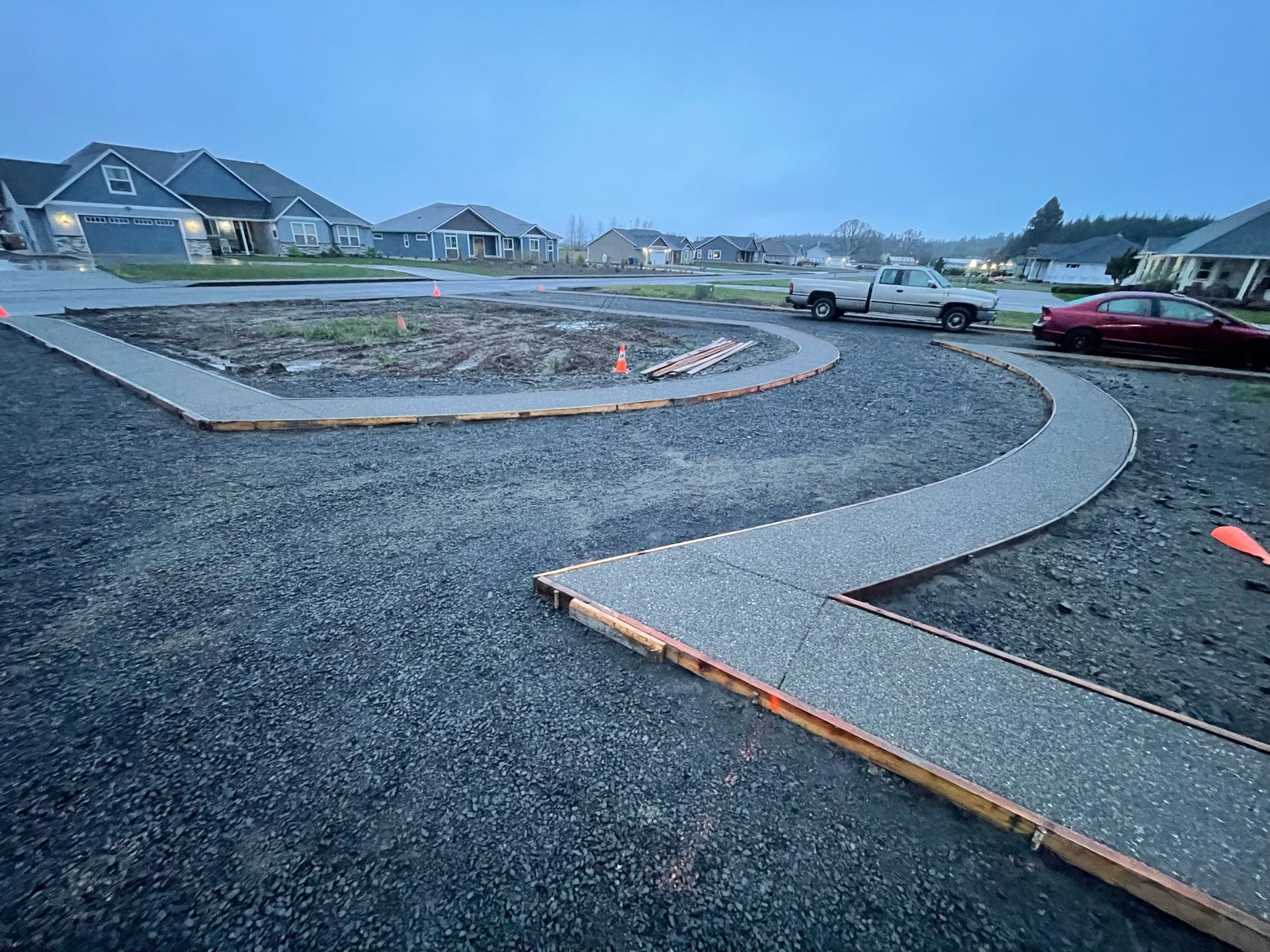 A concrete walkway is being built in a residential area.