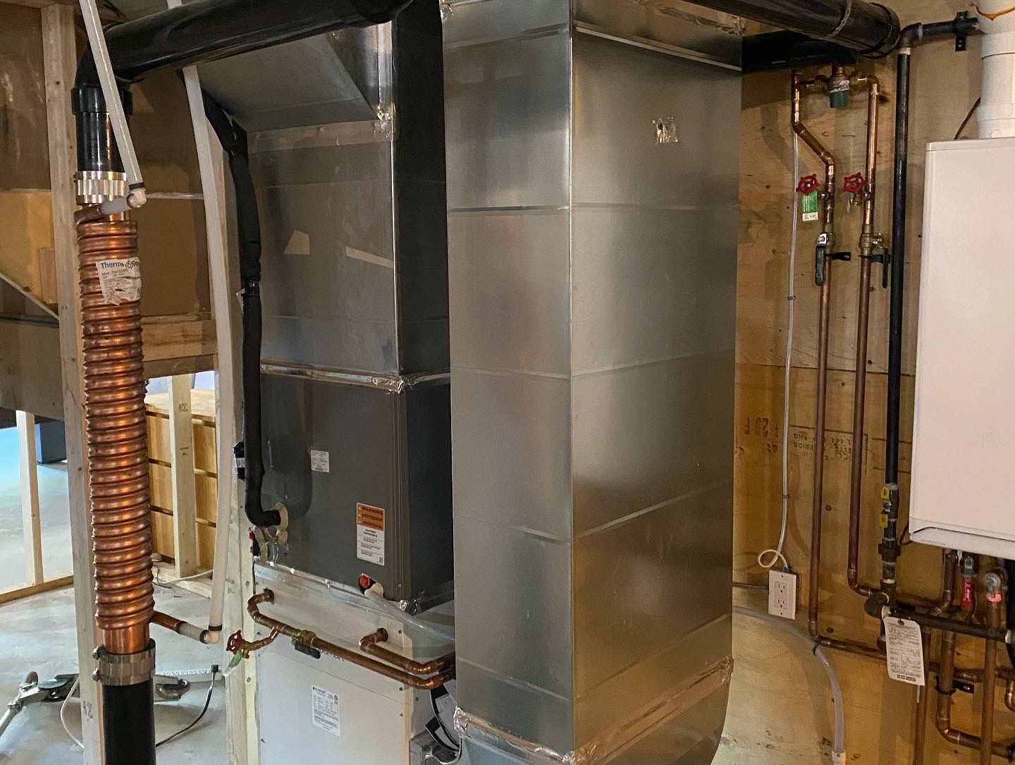 A room with a heater and pipes in it.