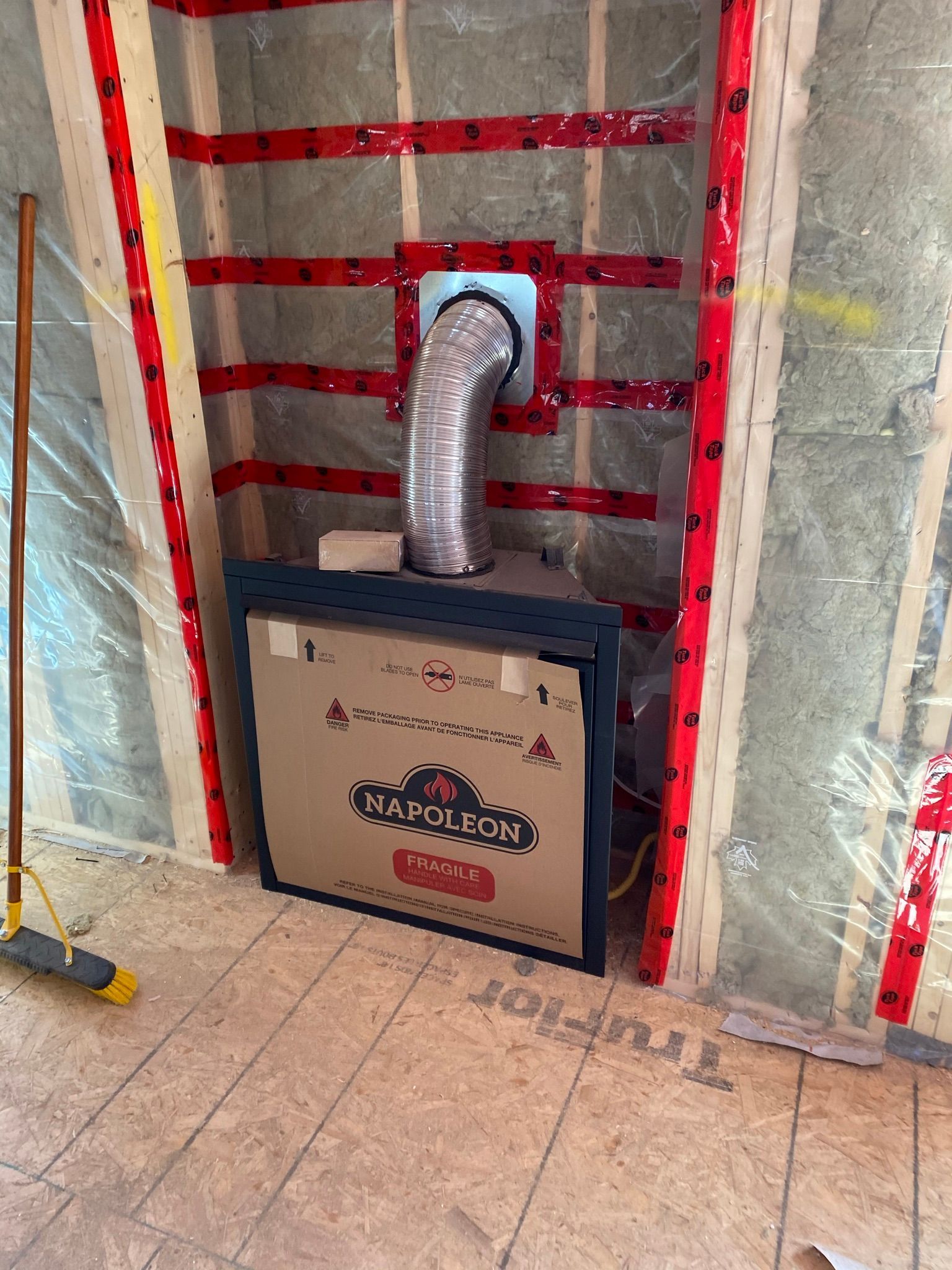 A box with a hose attached to it is sitting on the floor in a room.
