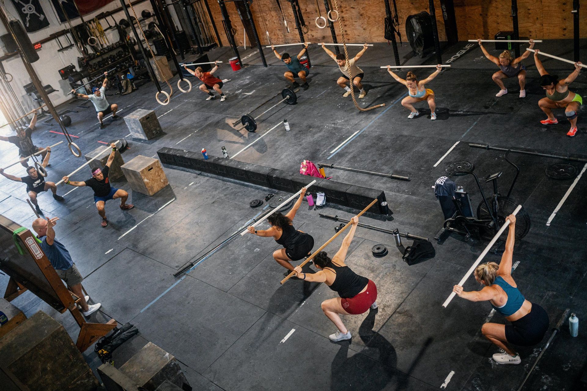 A group of people are doing exercises in a gym.