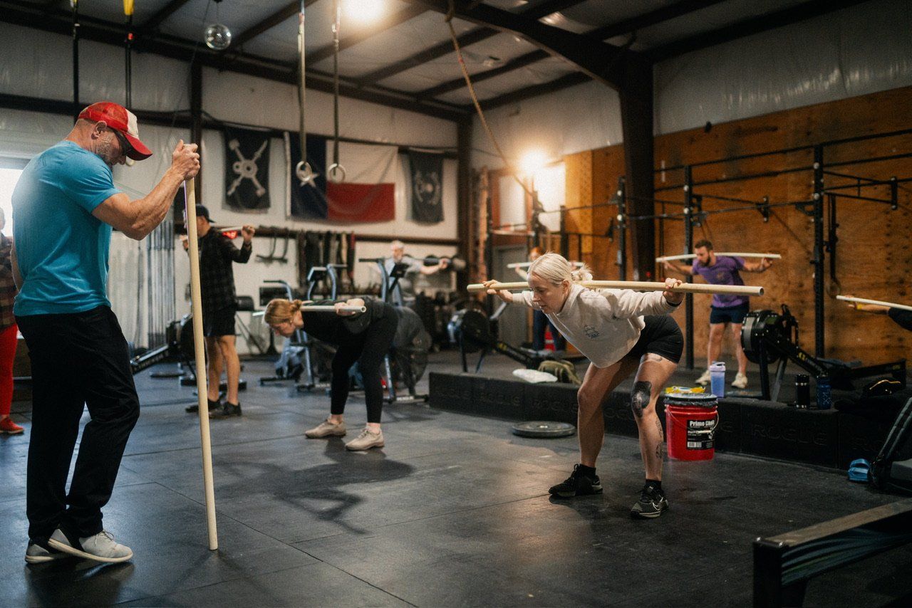 A group of people are doing exercises in a gym.