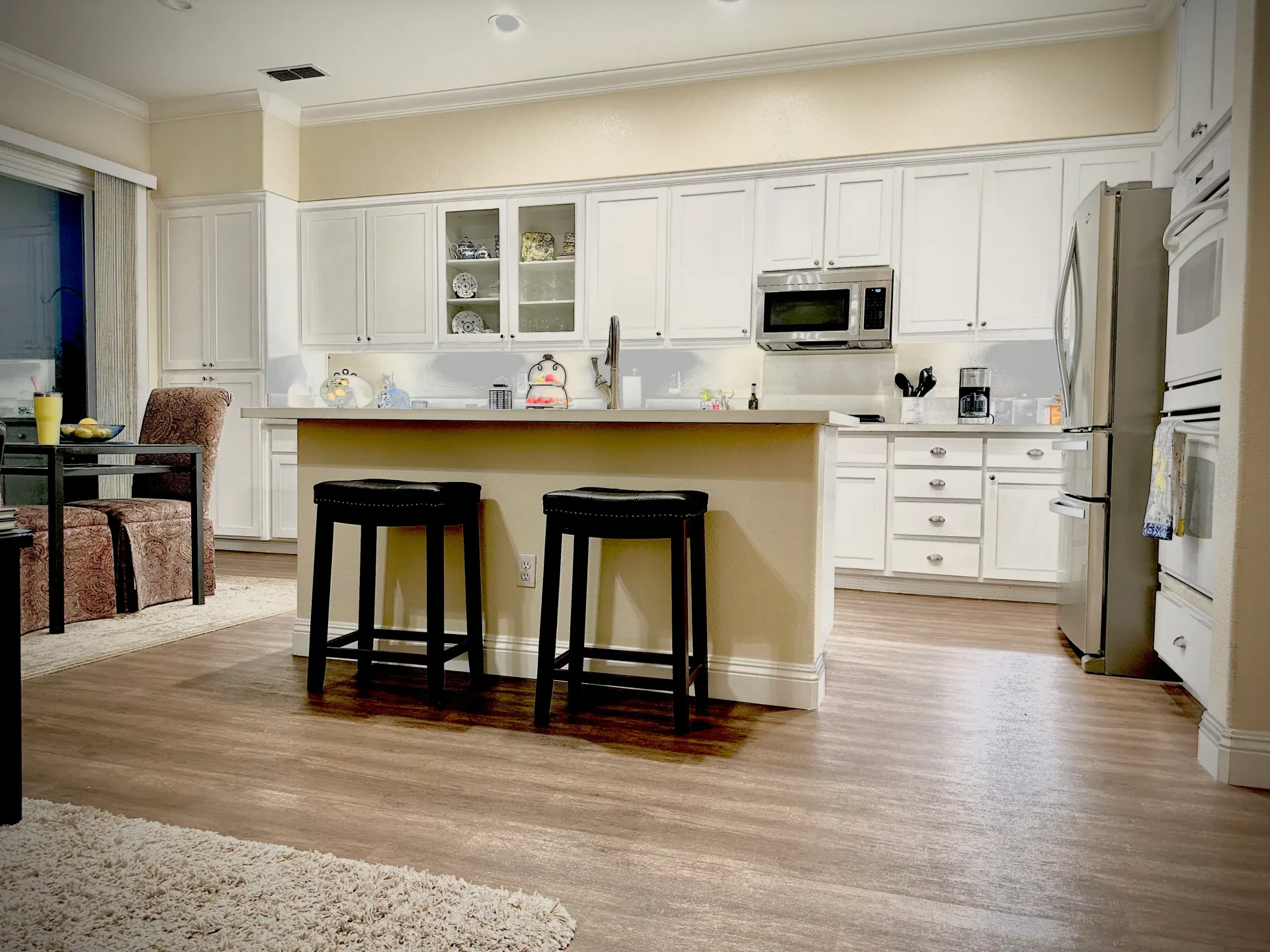 A kitchen with white cabinets and stainless steel appliances
