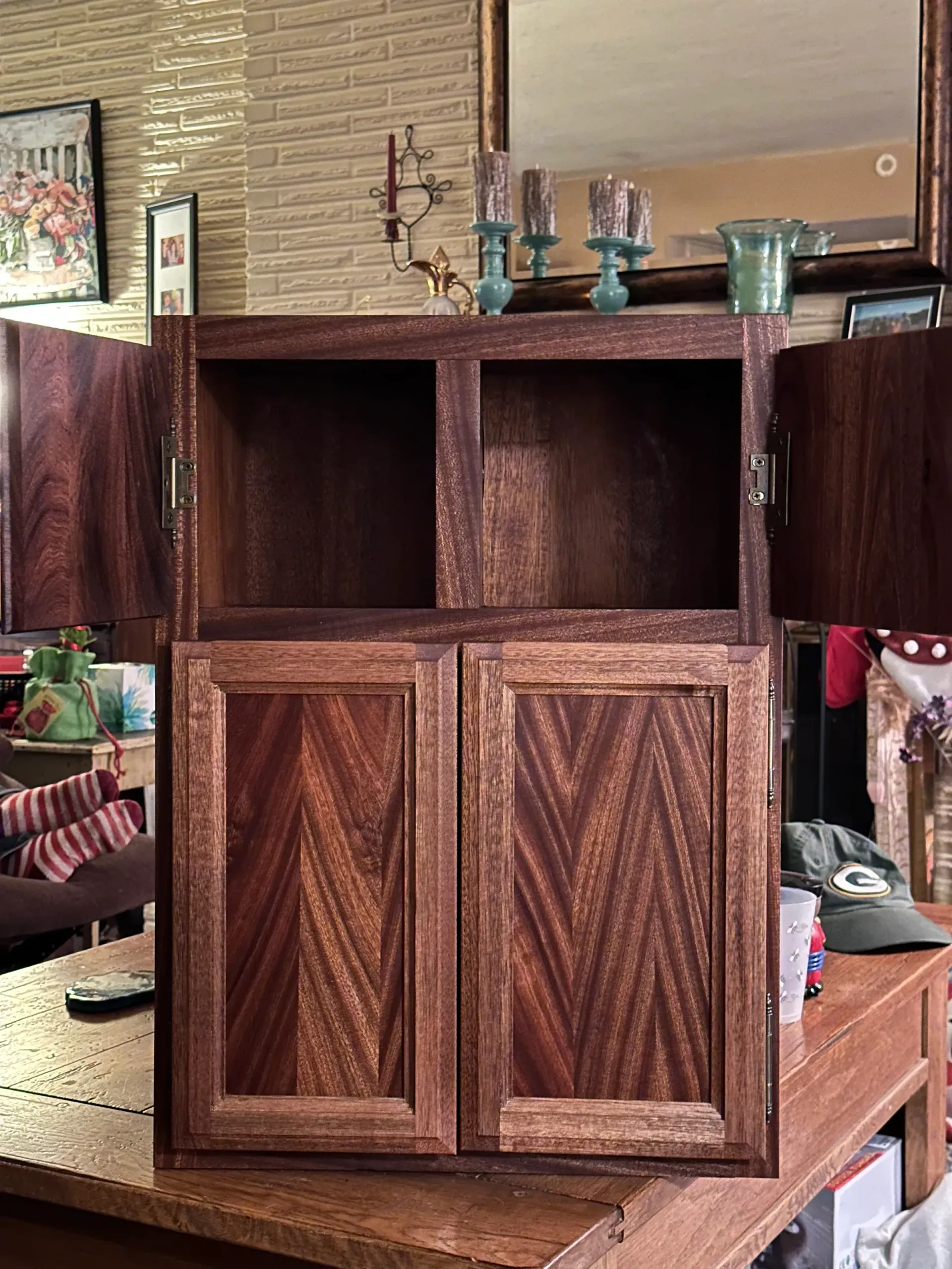 A wooden cabinet is sitting on a wooden table in a living room