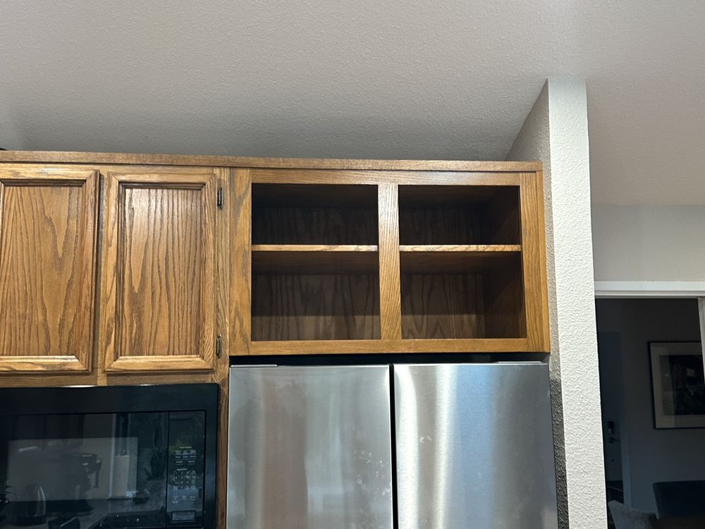 A kitchen with stainless steel appliances and wooden cabinets