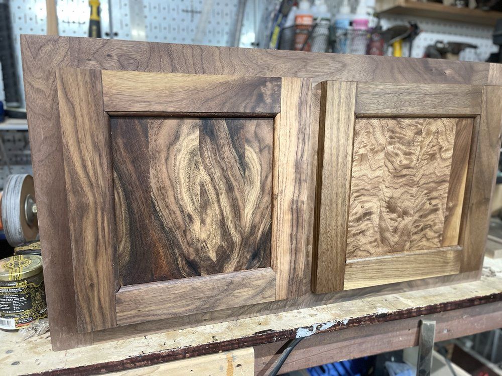 A piece of wood is sitting on top of a wooden table.