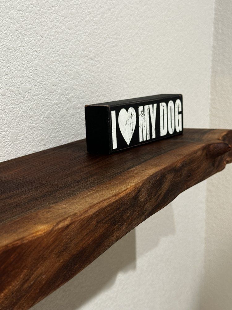 A wooden shelf with a sign that says i love my dog