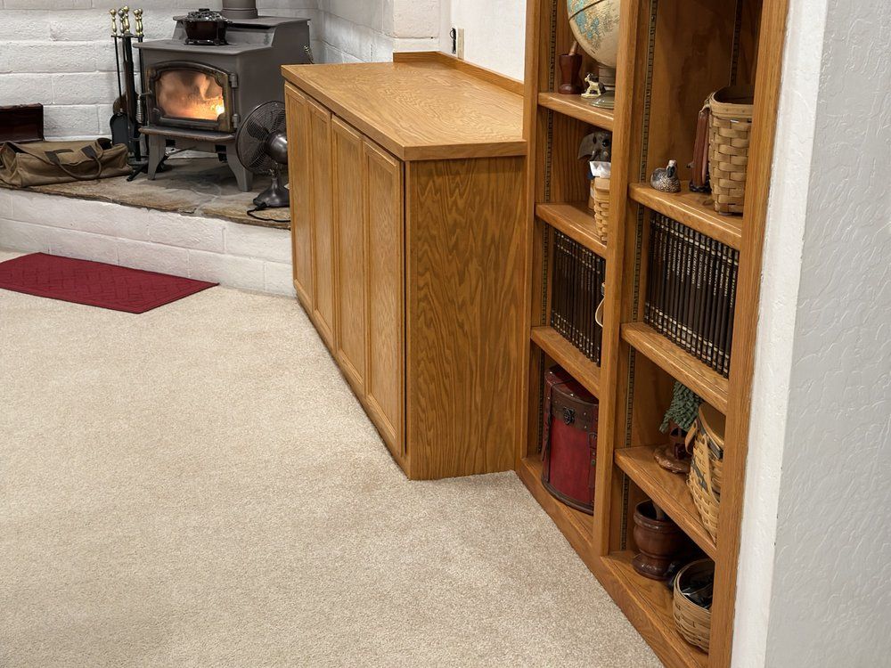 A living room with a wood stove and bookshelves