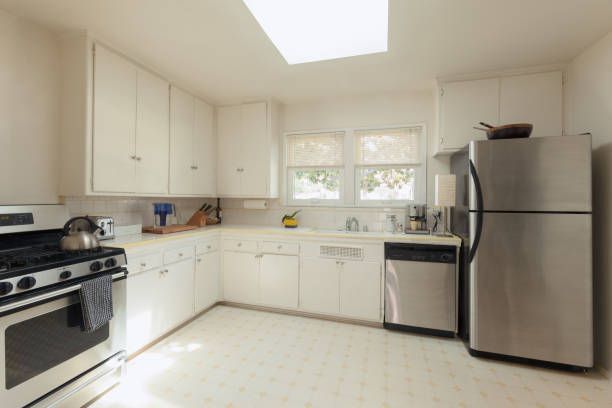 A kitchen with stainless steel appliances and white cabinets
