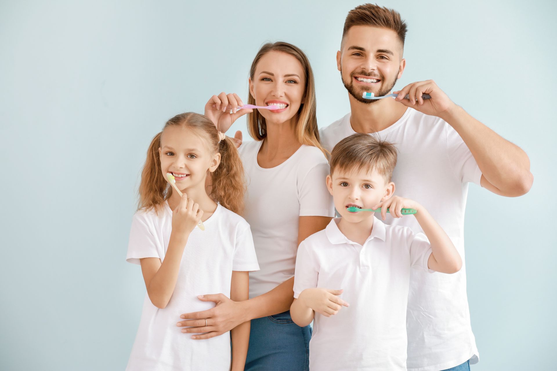 The family brushes teeth together, promoting healthy dental habits.