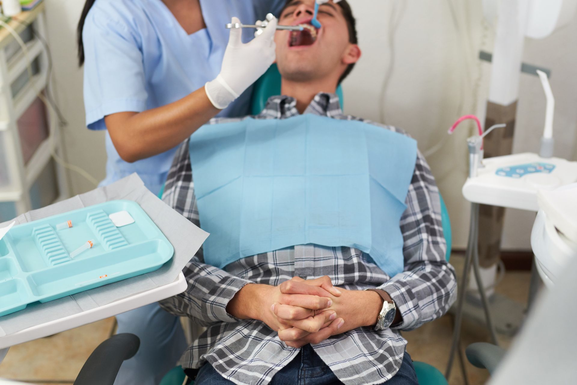 Dentist giving a patient a shot in the mouth. Dental office, patient seated. Dentist giving a patient a shot in the mouth. Dental office, patient seated.