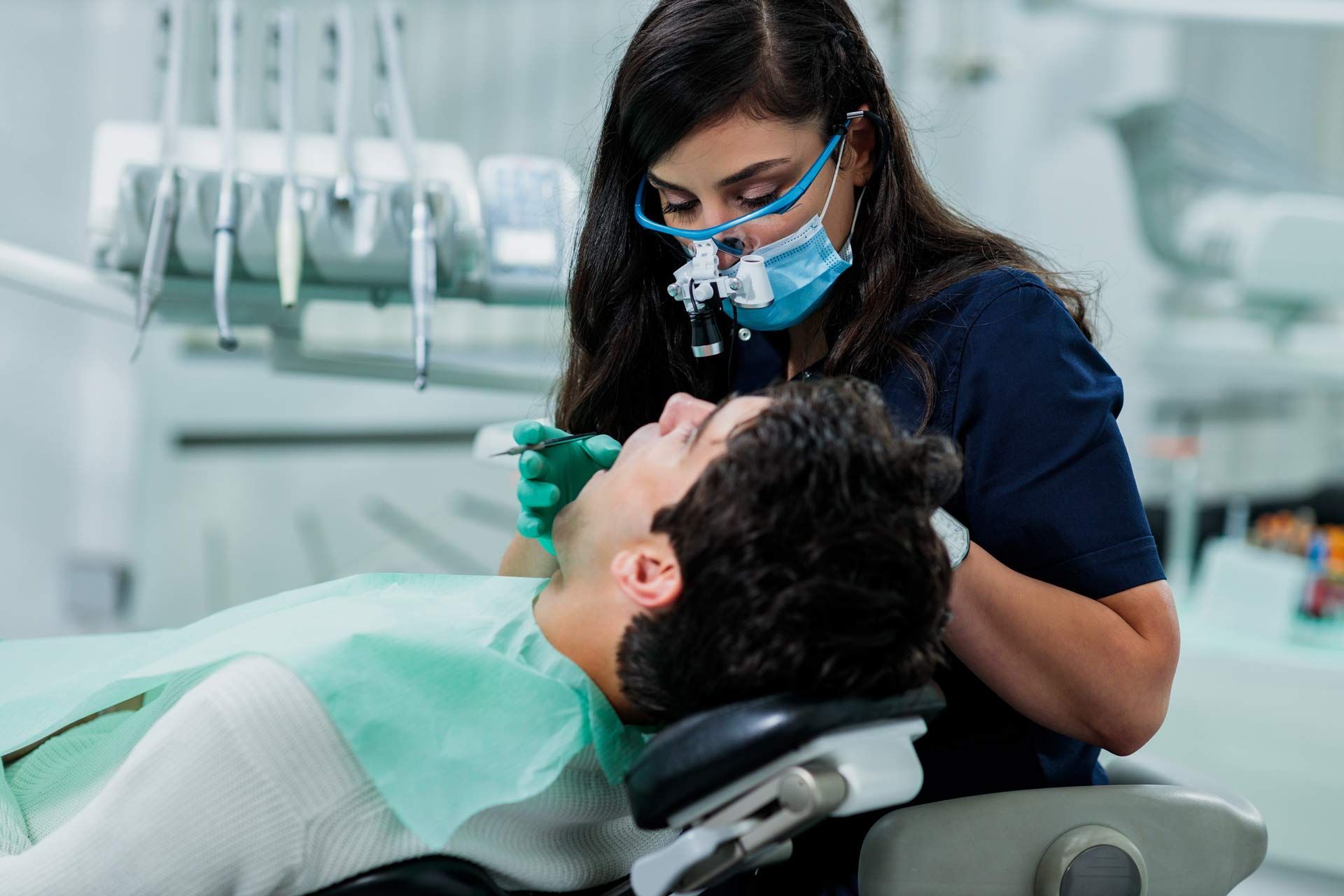 A dentist doing a procedure on a patient. A dentist doing a procedure on a patient.