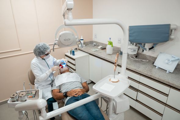 Dentist examining the teeth of the patient Dentist examining the teeth of the patient