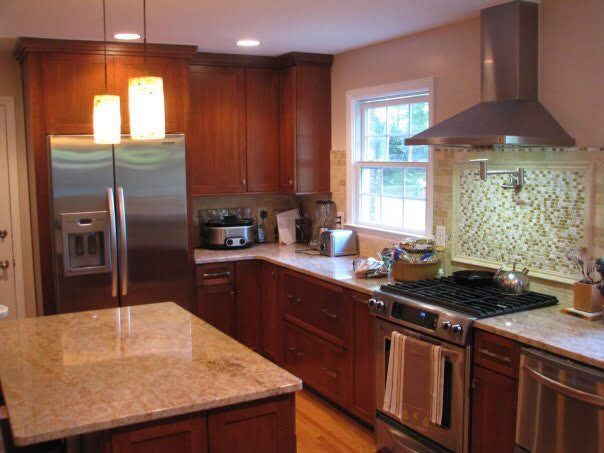 A kitchen with stainless steel appliances and wooden cabinets