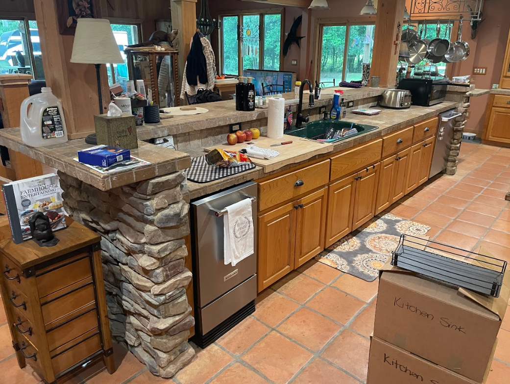 A kitchen with a large island and wooden cabinets.