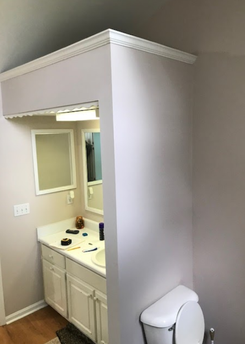 A bathroom with two sinks and a large mirror
