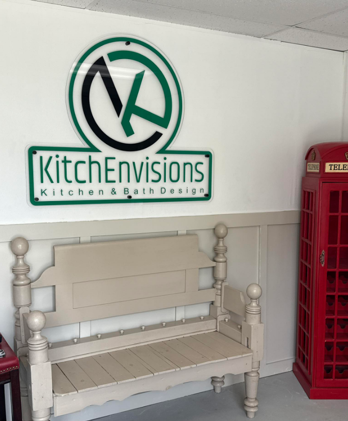 A kitchen envisions sign hangs above a bench