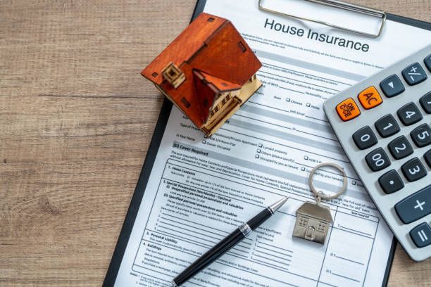  House insurance form with pen, calculator & small house symbolizing home insurance in Elyria, OH,
by Robert Taylor Companies.