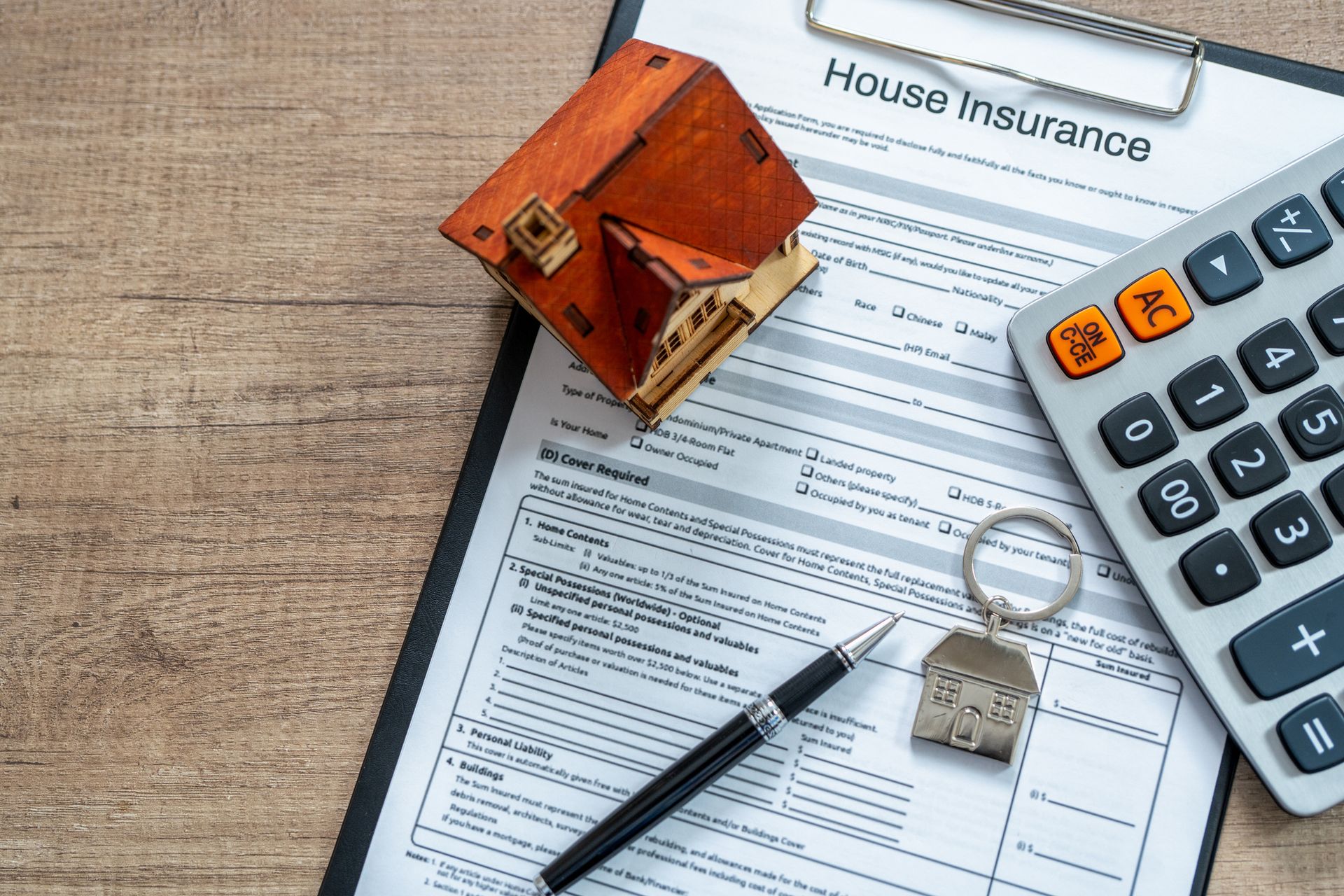 Home insurance documents and policy forms on a desk.