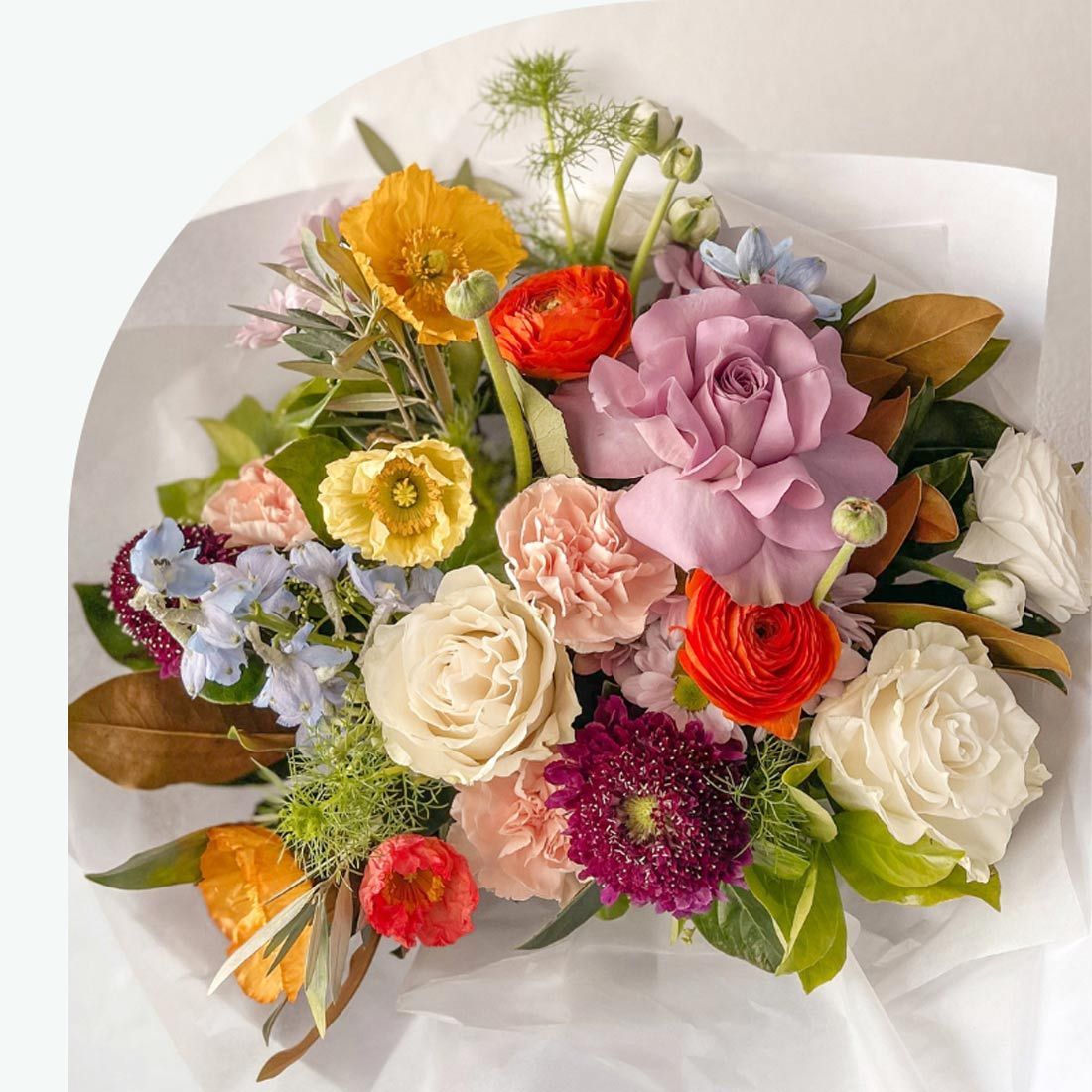 A Bouquet of Colorful Flowers Wrapped in White Paper — Suncoast Flowers in Birtinya, QLD