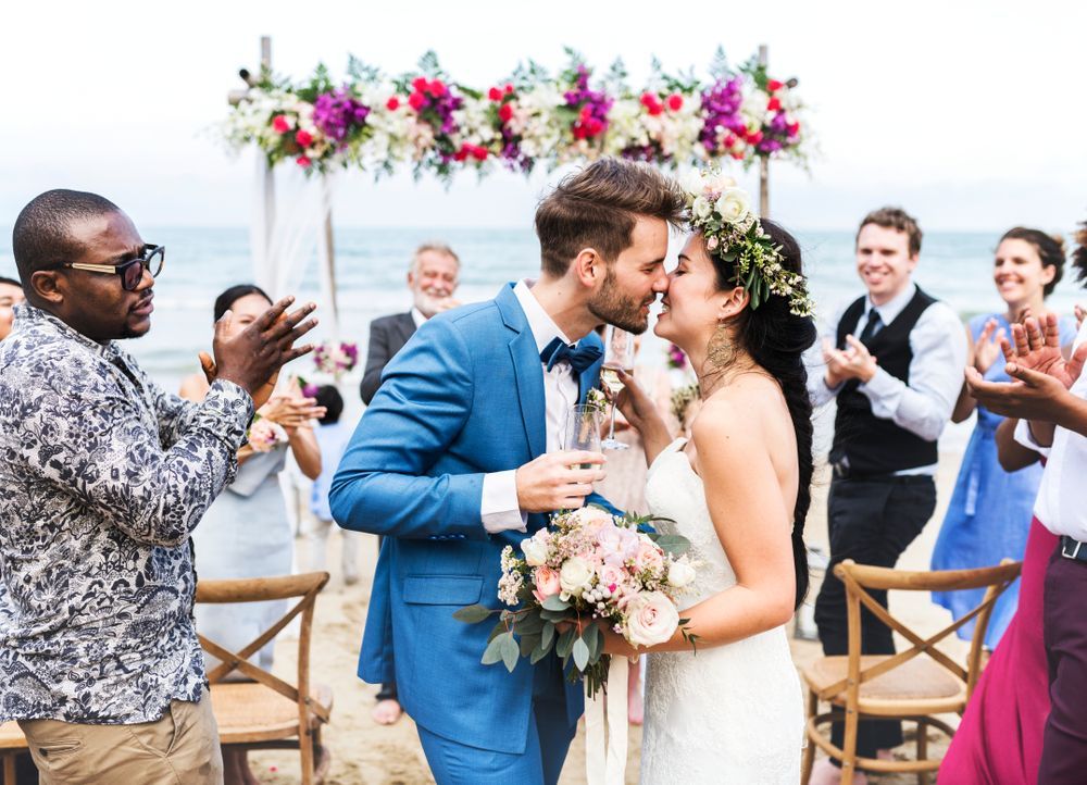 A Bride and Groom Kissing at Their Wedding on the Beach — Suncoast Flowers in Buderim, QLD