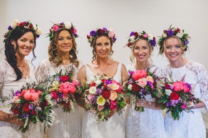 The Bride and Her Bridesmaids Are Wearing Flower Crowns and Holding Bouquets of Flowers — Suncoast Flowers in Birtinya, QLD