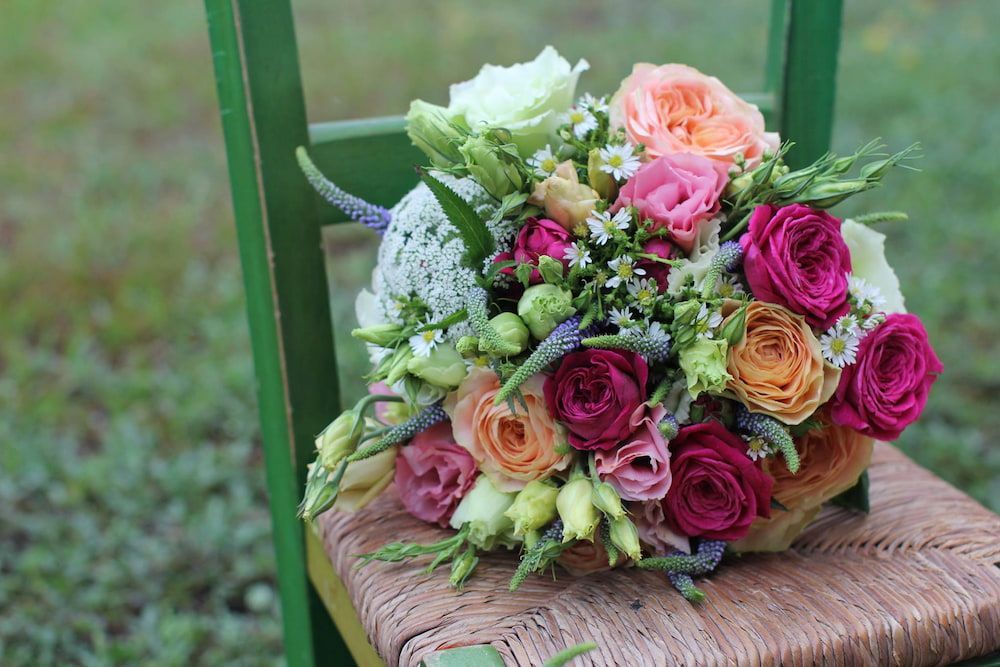 A Bouquet of Flowers is Sitting on a Green Chair — Suncoast Flowers in Caloundra, QLD