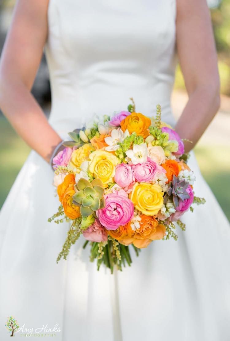 A Woman in a White Dress is Holding a Bouquet of Colorful Flowers — Suncoast Flowers in Buderim, QLD