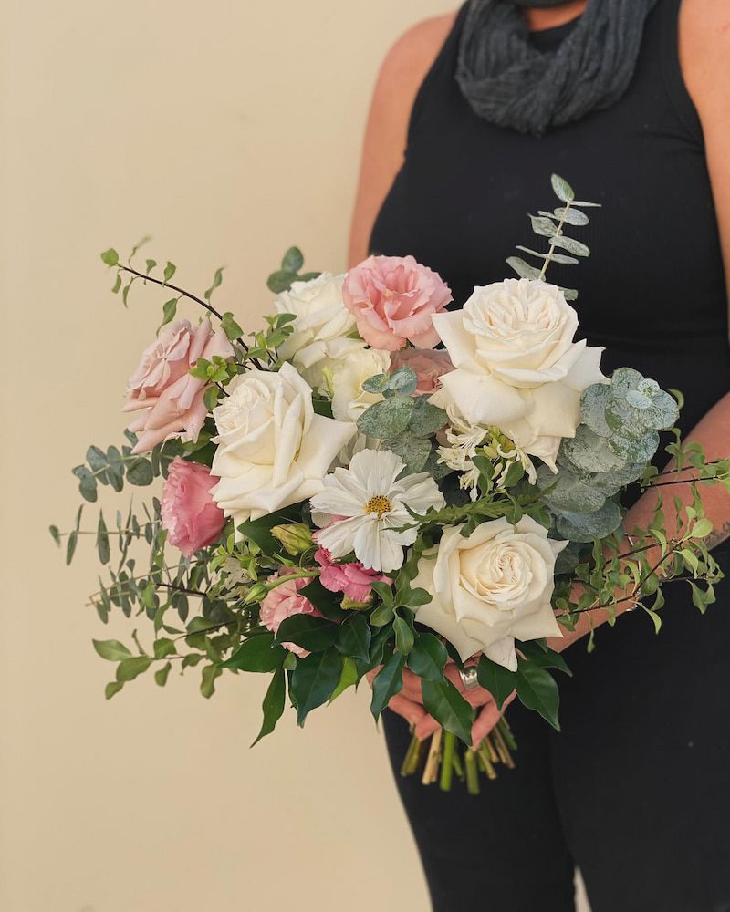A Woman in a Black Tank Top is Holding a Bouquet of Flowers — Suncoast Flowers in Buderim, QLD