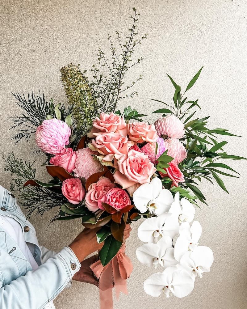 A Woman is Holding a Bouquet of Pink and White Flowers — Suncoast Flowers in Birtinya, QLD