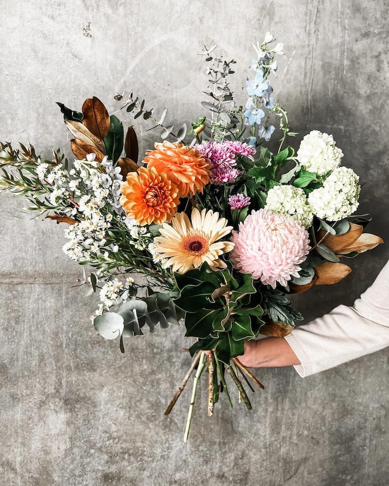 A Person is Holding a Large Bouquet of Flowers in Their Hands — Suncoast Flowers in Birtinya, QLD