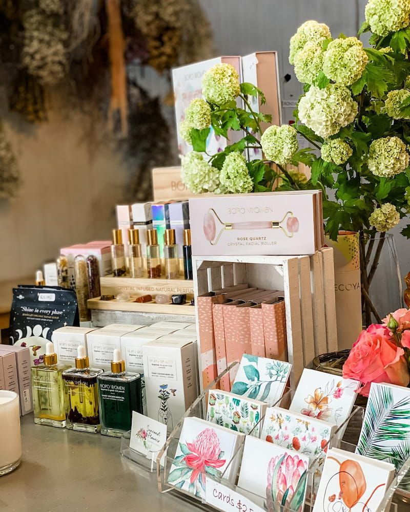 A Table Topped With a Variety of Cosmetics and Cards — Suncoast Flowers in Caloundra, QLD