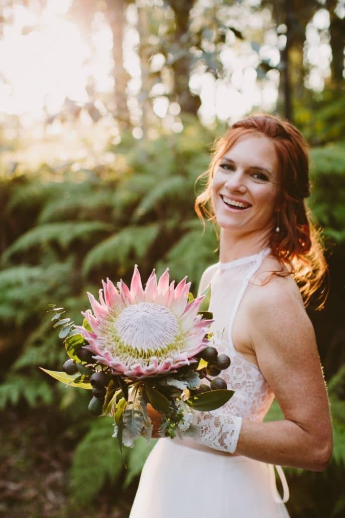 A Bride in a White Dress is Holding a Bouquet of Flowers in the Woods — Suncoast Flowers in Birtinya, QLD