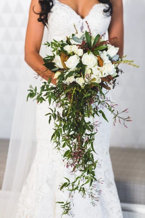 A Bride in a White Dress is Holding a Bouquet of Flowers — Suncoast Flowers in Birtinya, QLD