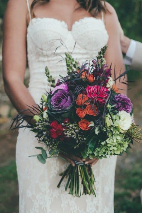 A Bride in a White Dress is Holding a Bouquet of Flowers — Suncoast Flowers in Birtinya, QLD