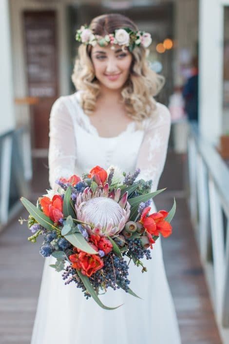 The Bride is Wearing a Flower Crown and Holding a Bouquet of Flowers — Suncoast Flowers in Birtinya, QLD