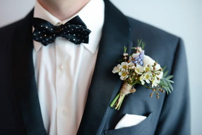 A Man in a Suit and Bow Tie Has a Boutonniere on His Jacket — Suncoast Flowers in Birtinya, QLD