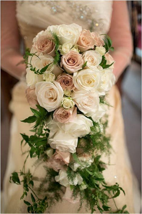 A Bride is Holding a Bouquet of White and Pink Roses — Suncoast Flowers in Birtinya, QLD