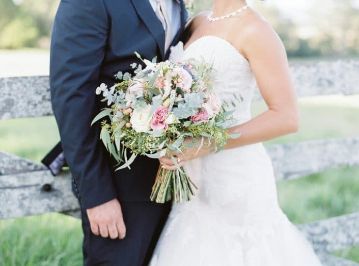 A Bride and Groom Are Posing for a Picture — Suncoast Flowers in Birtinya, QLD