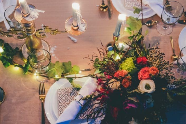A Table With Plates, Candles, and Flowers on It — Suncoast Flowers in Birtinya, QLD