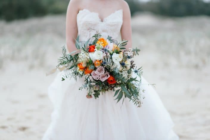 A Bride in a White Dress is Holding a Bouquet of Flowers — Suncoast Flowers in Birtinya, QLD