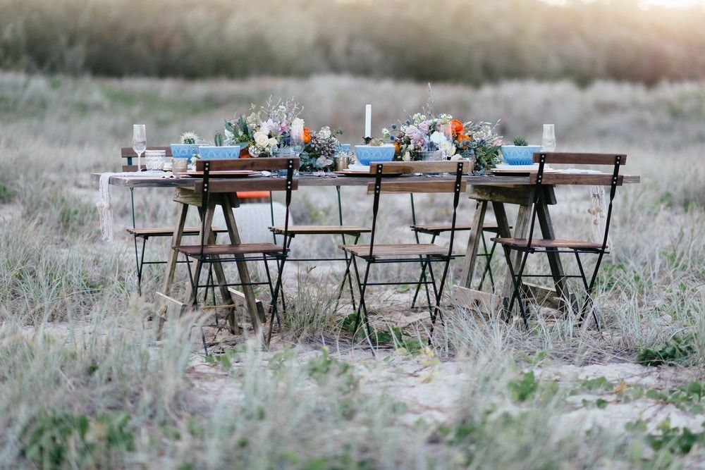 A Table and Chairs Are Sitting in the Middle of a Field — Suncoast Flowers in Birtinya, QLD