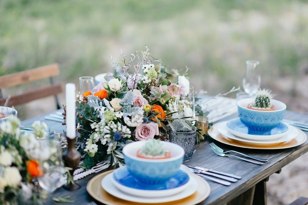 A Table Set With Plates, Bowls, Candles and Flowers — Suncoast Flowers in Birtinya, QLD