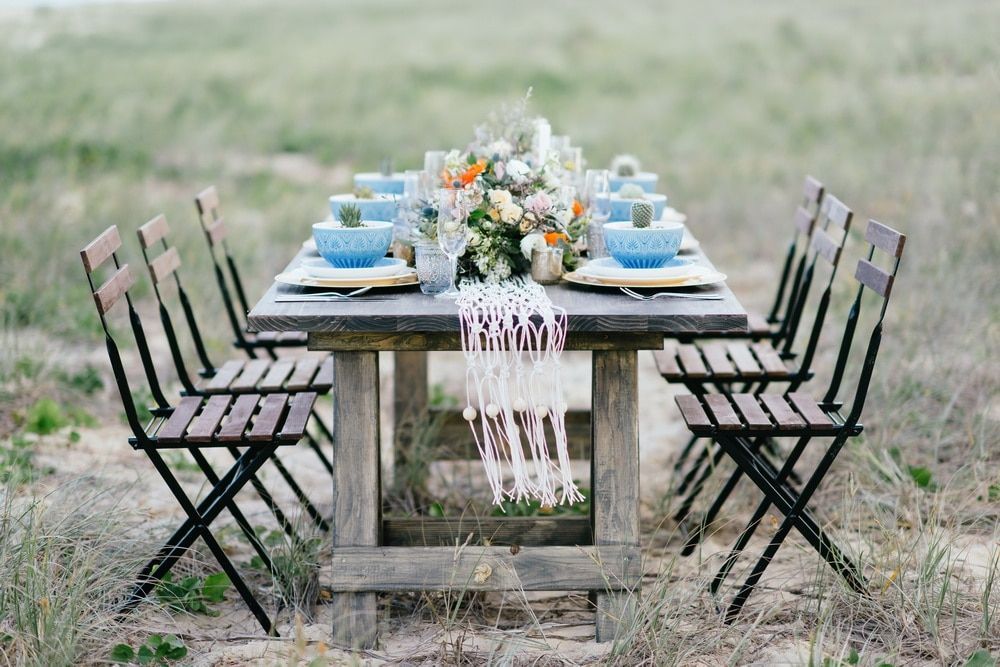 A Wooden Table and Chairs Are Sitting in the Middle of a Field — Suncoast Flowers in Birtinya, QLD