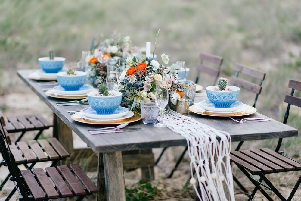 A Long Table With Plates, Bowls, Glasses, and Flowers on It — Suncoast Flowers in Birtinya, QLD