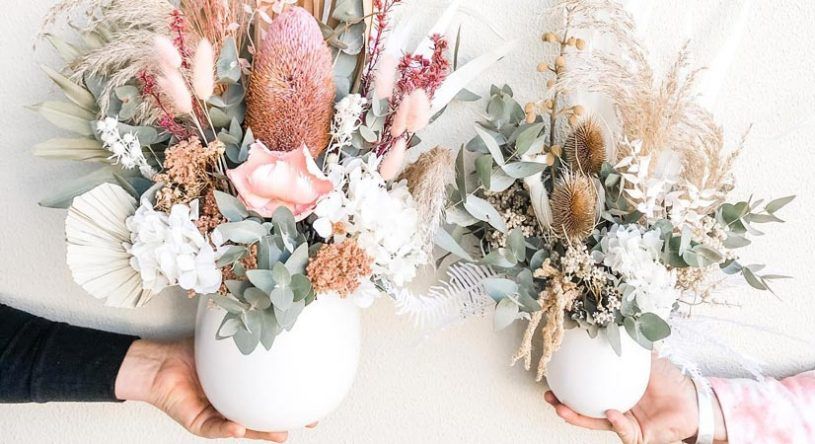 A Person is Holding Two Vases Filled With Dried Flowers — Suncoast Flowers in Birtinya, QLD