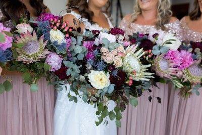 A Bride and Her Bridesmaids Are Holding Bouquets of Flowers — Suncoast Flowers in Birtinya, QLD