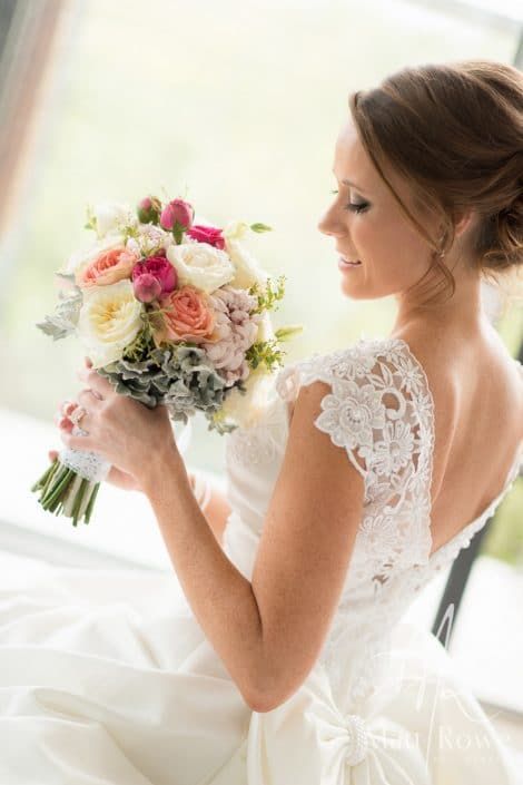 A Woman in a Wedding Dress is Holding a Bouquet of Flowers — Suncoast Flowers in Birtinya, QLD