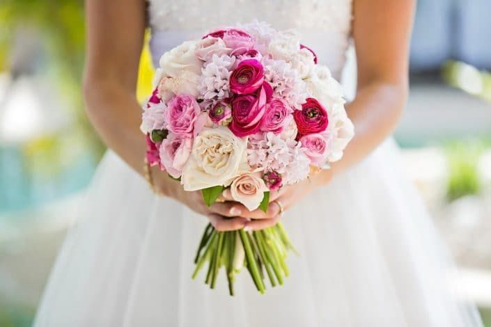 A Bride in a White Dress is Holding a Bouquet of Pink and White Flowers — Suncoast Flowers in Birtinya, QLD