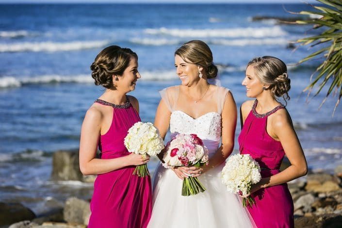 A Bride and Her Bridesmaids Are Posing for a Picture on the Beach — Suncoast Flowers in Birtinya, QLD